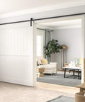 10 Foot Barn Door Hardware Kit For Single Sliding Door Heavy Duty Black Carbon Steel Track And J Shape Rail Includes All Necessary Hardware For Quick Smooth Installation For A 65 Inch Closet Panel No Door installed in a living room