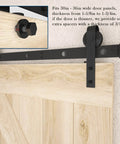 Close-up of black J-shaped roller on 6.6FT Barn Door Hardware Kit with Heavy Duty Modular Sliding Track installed on wooden door panel.