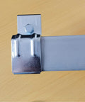 Close-up of galvanized steel heavy duty box rail hanger bracket for barn doors exterior hardware with bolt and bendable tab.