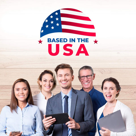 Group of smiling people standing in front of a "Based in the USA" sign with an American flag design above.
