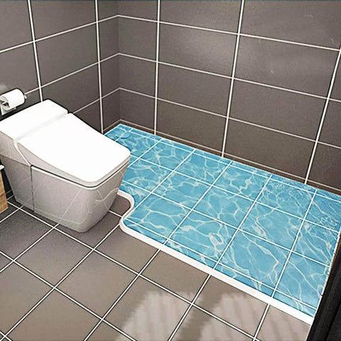 67 Inch Collapsible Shower Threshold Water Dam installed in a wheelchair-accessible bathroom with blue tile flooring.