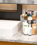4 Pack 9.5 Inch Clear Acrylic Lazy Susan Turntable Organizer with pillars on bathroom countertop with toiletries