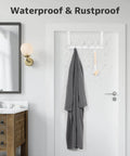 Bathroom door with waterproof and rustproof over-the-door rack holding wet towel and brush