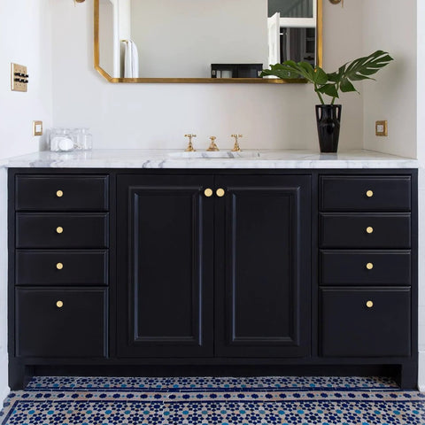 Solid Brass Brushed Gold Cabinet Knobs Set on black bathroom vanity with marble top