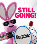 Cartoon pink bunny with sunglasses holding a drum and Energizer battery, with "Still Going!" text.