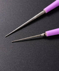Close-up of the Bead Hole Reamer Tool For Jewelry Making By EXCEART Pro Grade Hole Enlarger, featuring fine tips and purple handles.