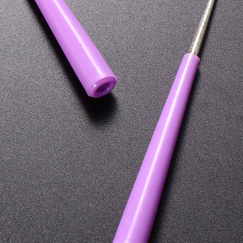 Close-up of pink Bead Hole Reamer Tool for Jewelry Making By EXCEART with an ergonomic handle on a dark surface.
