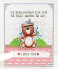 Cute bear-themed greeting card with "I Love You" message and heart accents, featuring playful bear illustration holding an arrow.