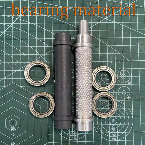 Two bearing shafts and rings on a cutting mat, labeled 'bearing material'