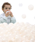 Child playing with 100 Ball Pit Balls Phthalate Free BPA Free Crush Proof Plastic - Beige Colors in Reusable Play Toys for Kids