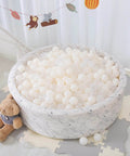 100 Ball Pit Balls Phthalate Free BPA Free Crush Proof Plastic - Beige Colors in a round playpen with teddy bear