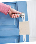 Three-piece, no-tool door silencers prevent finger pinches and door slam noise by snapping onto the door knob on a blue door.