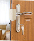 Experience quiet, safe doors with these tool-free door silencers shown installed on a wooden door handle, beige fabric visible.