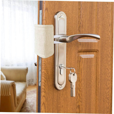 Experience quiet, safe doors with these tool-free door silencers shown installed on a wooden door handle, beige fabric visible.