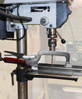 Beefy 3 Inch Bench Clamp With Metal Swivel Pads That Prevent Marring And Even Pressure, shown on a drill press platform