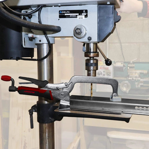 Beefy 3 Inch Bench Clamp With Metal Swivel Pads That Prevent Marring And Even Pressure, shown on a drill press platform