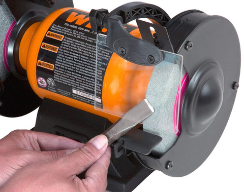 Using 2.1 Amp Bench Grinder with flexible work light for tool sharpening, visible are 6 inch by 3 quarter inch grinding wheels, black and orange.