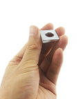 Hand holding Beveled Square Washers 3/8 in ID by 7/8 in OD galvanized carbon steel pack of 10 for structural and automotive joints