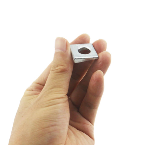 Hand holding Beveled Square Washers 3/8 in ID by 7/8 in OD galvanized carbon steel pack of 10 for structural and automotive joints