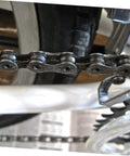 Close-up of a roller chain with connecting links on a bicycle, showcasing the 10 Pieces Heavy Duty Roller Chain Connecting Links Set For Chain Connectors And Roller Chains In Steel Connecting Link Buckle Durable Chain Accessories For Reliable Fastening And Long Service Life.