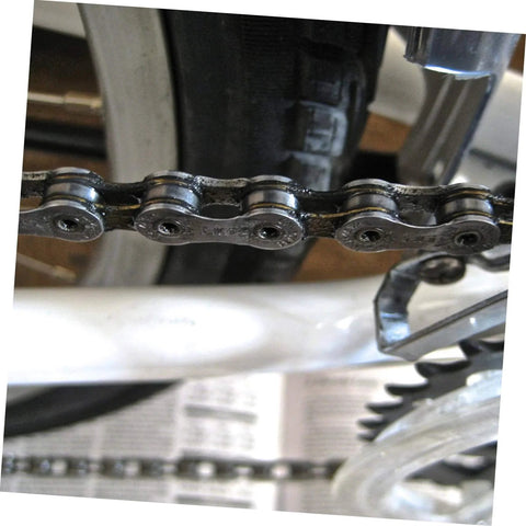 Close-up of a roller chain with connecting links on a bicycle, showcasing the 10 Pieces Heavy Duty Roller Chain Connecting Links Set For Chain Connectors And Roller Chains In Steel Connecting Link Buckle Durable Chain Accessories For Reliable Fastening And Long Service Life.