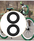 Black bicycle with focus on two replacement rubber wheels for smooth rolling on wooden path.