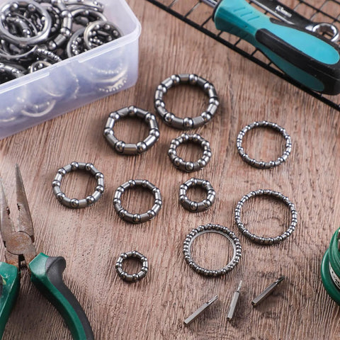 Five Sets Bike Bearing Kit With Fifty Bearings In Ten Sizes From 4mm To 8mm for mountain and road bicycles on a wooden table