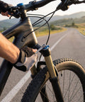 Cyclist using 10 In 1 Bike Multitool Wrench For Road And Mountain Bikes On The Go on bike fork maintenance outdoors