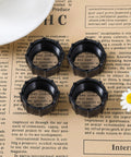 Four Pack 17mm Tightening Nuts For Car Phone Mounts Replacement Parts laid out on newspaper