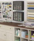 Wall-mounted 24-Drawer Plastic Storage Cabinet For Garage Organization And Craft Storage displayed in a craft room.