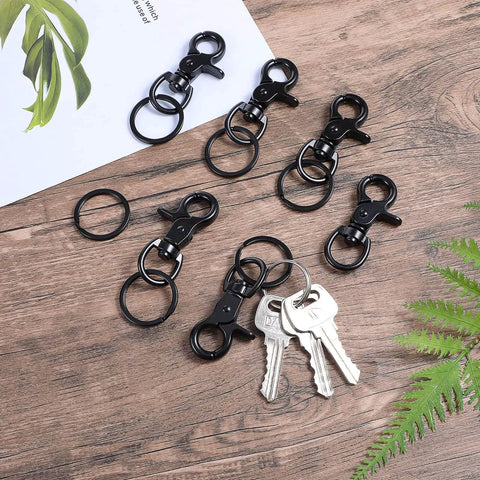 Six Pcs Black 60mm Zinc Alloy Trigger Carabiner Heavy Duty Swivel Snap Hooks With 360 Degree Rotatable Eye Clips on wooden surface