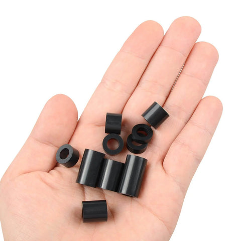 Hand holding Black ABS Round Washers Set Assortment Kit NonThreaded for M6 Screws with various thicknesses