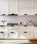 Stylish white kitchen with Four Pack Stick On Cabinet Handles No Drill Drawer Pulls Adhesive Door Handles installed on cabinets.