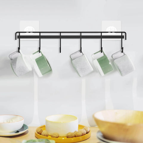 Adhesive Kitchen Hooks Utensil Hanger Holder Hanging Rack 2 Pack with mugs, wall mounted for cups, black metal rail with hooks.