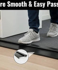 Person stepping over Black Adjustable Aluminum Threshold, Threshold Extension, Short Width, Hidden Screw Design, 36 Inch, in doorway