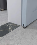 Black aluminum floor guide for sliding barn doors and bypass systems installed on marble flooring