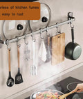 Kitchen Hooks Utensil Holder Wall Utensil Rack with pots, pans, and utensils hanging on a 45cm black aluminum rail above a stovetop.