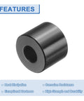 Close-up of a round black anodized aluminum spacer from Ten Piece Aluminum Spacer Set One Quarter Inch Bore Five Eighths Inch OD One Half Inch Length Black Anodized Round Unthreaded Standoff Bushings For Do It Yourself Projects And Electronics Durable Corrosion Resistant.