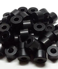 Pile of black anodized aluminum spacers with 3/4 inch outer diameter and 3/8 inch bore, unthreaded for precise mounting.