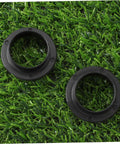 Two Pack Black Axle Protection Covers for Bike Bearings on grass background