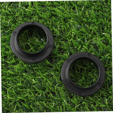 Two Pack Black Axle Protection Covers for Bike Bearings on grass background