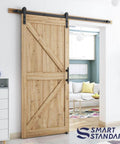 6.8 ft heavy duty sliding barn door hardware kit in black with I shape hanger installed on wooden door in living room