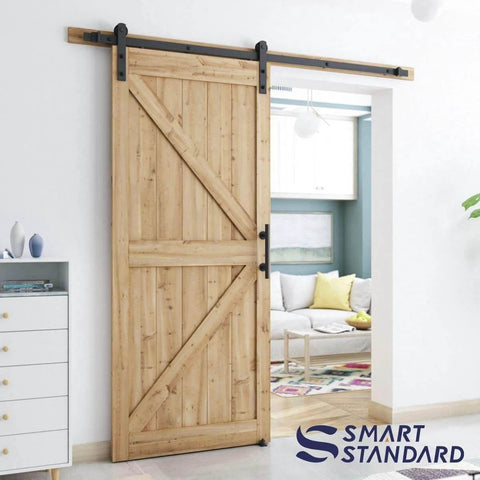 6.8 ft heavy duty sliding barn door hardware kit in black with I shape hanger installed on wooden door in living room