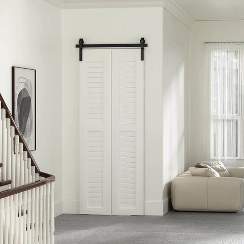 Installed 36" Bi-Folding Sliding Barn Door Hardware Track Kit, side mounted black roller, in a modern living room setting, door not included