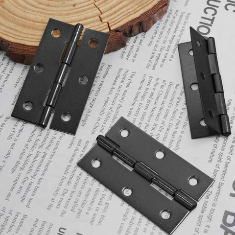 12 Pack 2.5 Inch Black Butt Door Hinges With Ball Bearing For Cabinets And Windows placed on a wooden and paper background