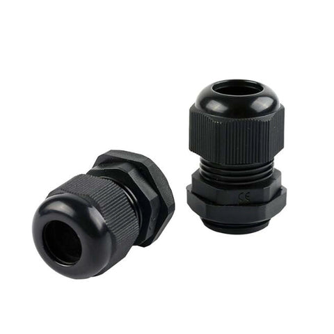 Close-up of two black plastic cable glands, one oriented upright and the other on its side, showing threaded material and opening.