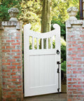 White wooden gate with installed 18 Inch Heavy Duty Cane Bolt Drop Rod For Gates And Fences Ground Latch For Wooden And Metal Gates.