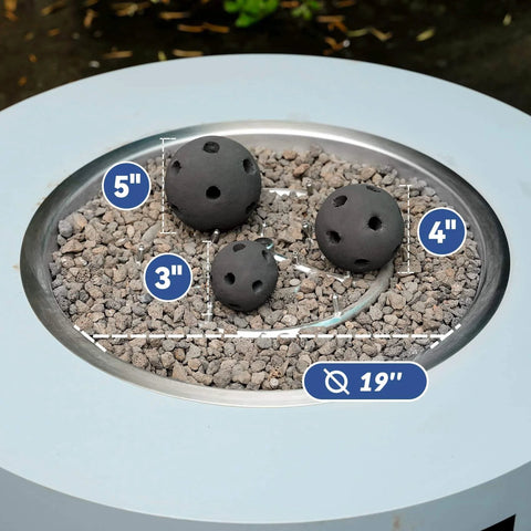 Hollow Ceramic Balls set of 12 round fire stones for 19 inch outdoor fire pit, showing 3, 4, and 5 inch black balls on gravel
