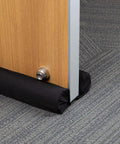 Door Noise Blocker 36 Inch Black Draft Stopper Silencer installed under wooden door, showing soundproof and energy-saving features.