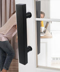Double Sided Push Pull Door Handles In Black Finish For Sliding Doors And Glass Panels, installed on a glass door